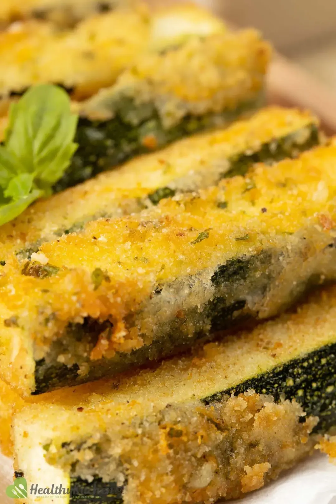 A close-up shot of zucchini fries, with a crispy breadcrumb coating