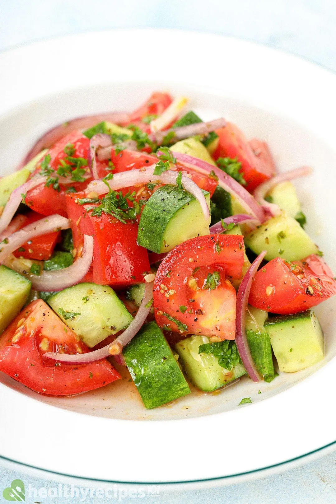 a plate of tomato cubes and cucumber cubed