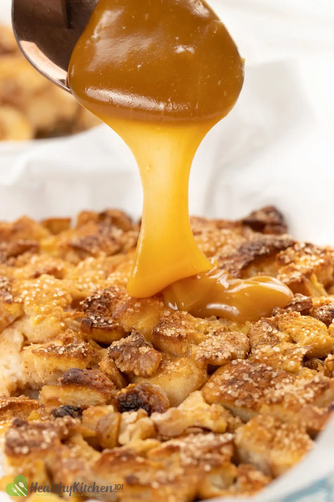 caramel sauce pouring to the bead pudding
