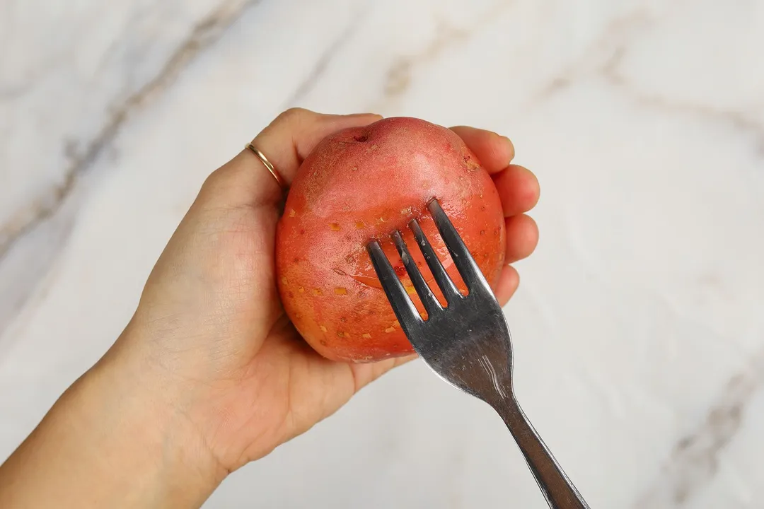 a folk prick a potato on hand