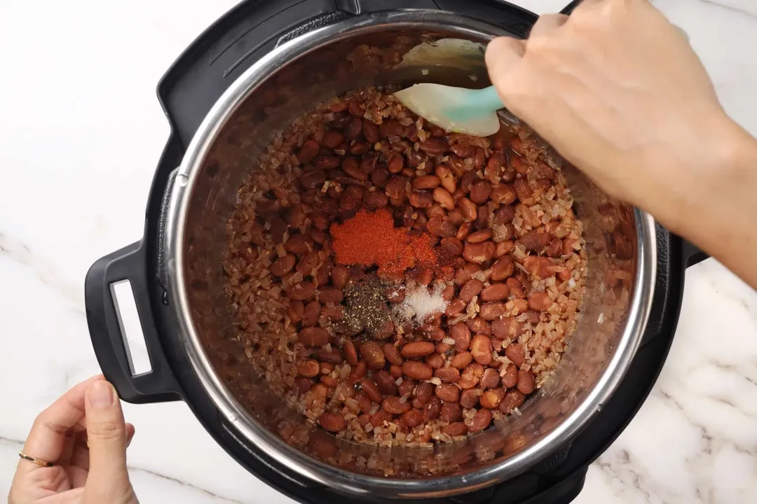 Stir spices into the cooked beans