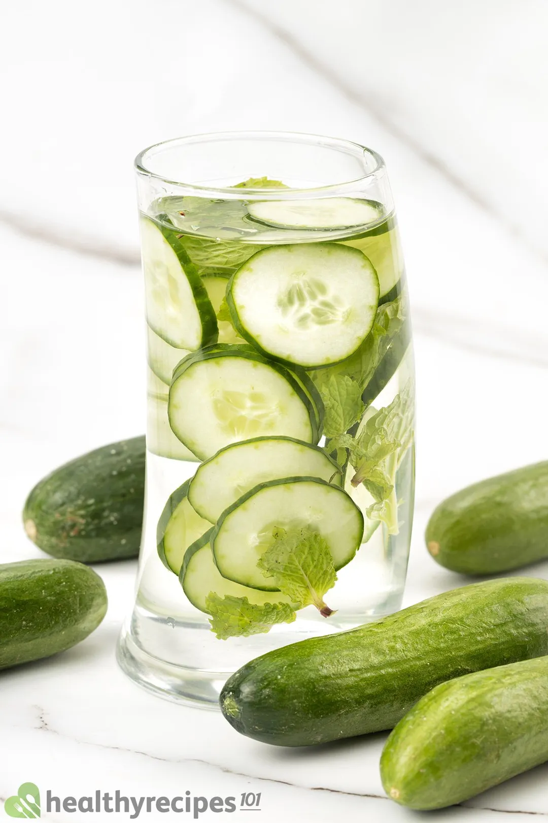 a glass of Cucumber Mint Water decorated by cucumber