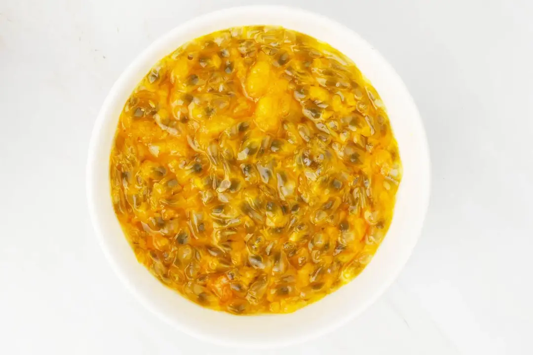 A bowl of passion fruit pulp and seeds