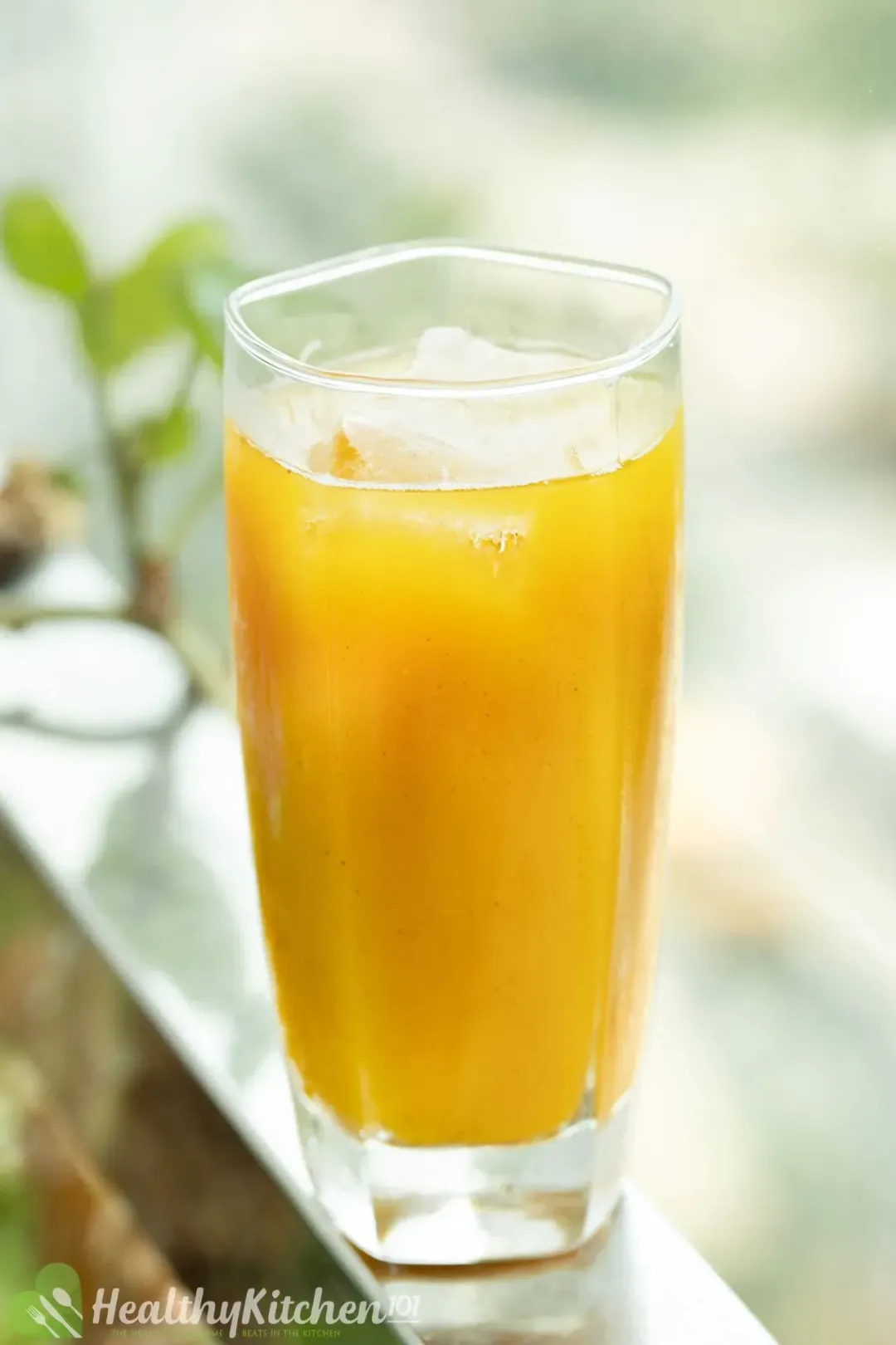 A glass of iced Harry Potter pumpkin juice on a steel railing