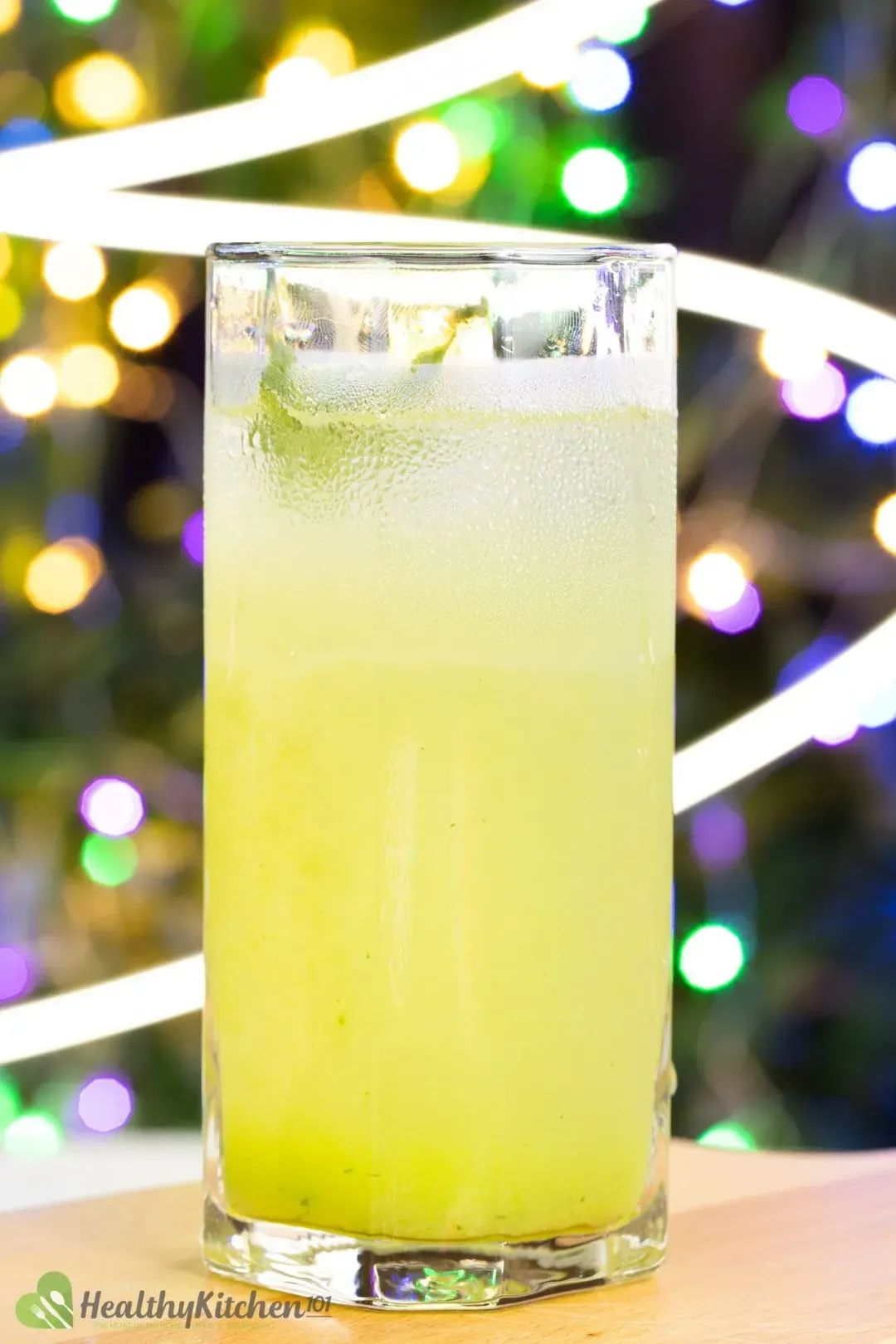 A cucumber lime drink taken in front of a christmas tree