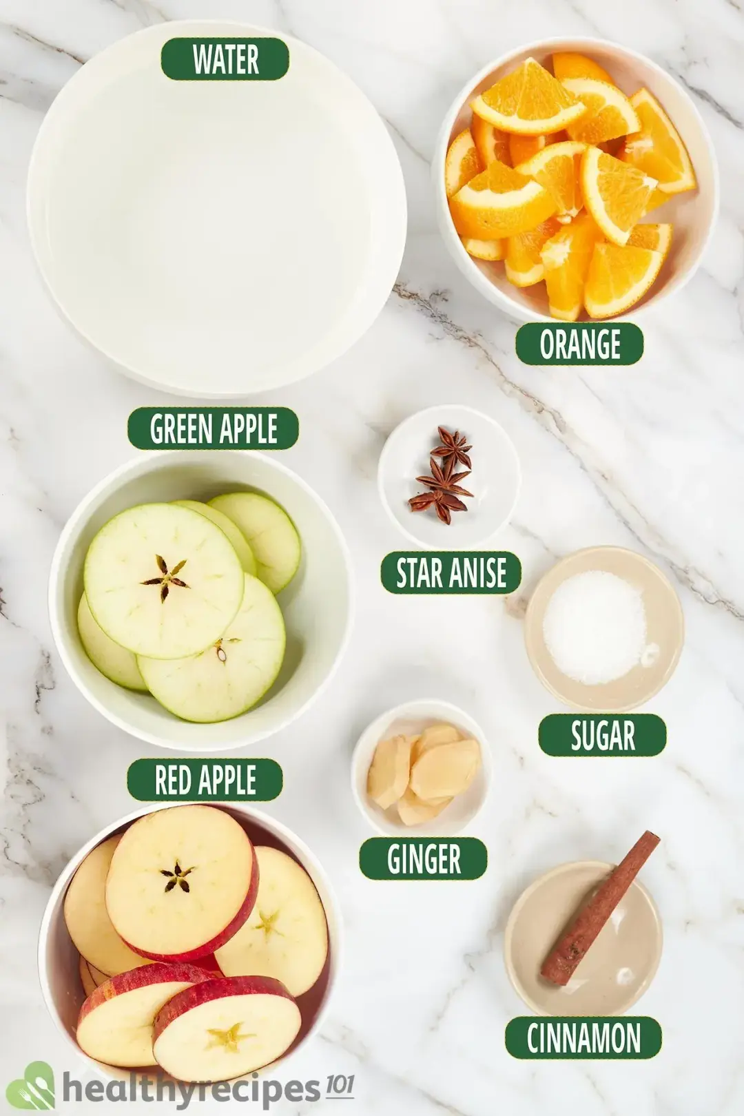 Ingredients in separate bowls: water, orange triangles, green apple slices, red apple slices, star anise, peeled ginger, sugar, and a cinnamon stick