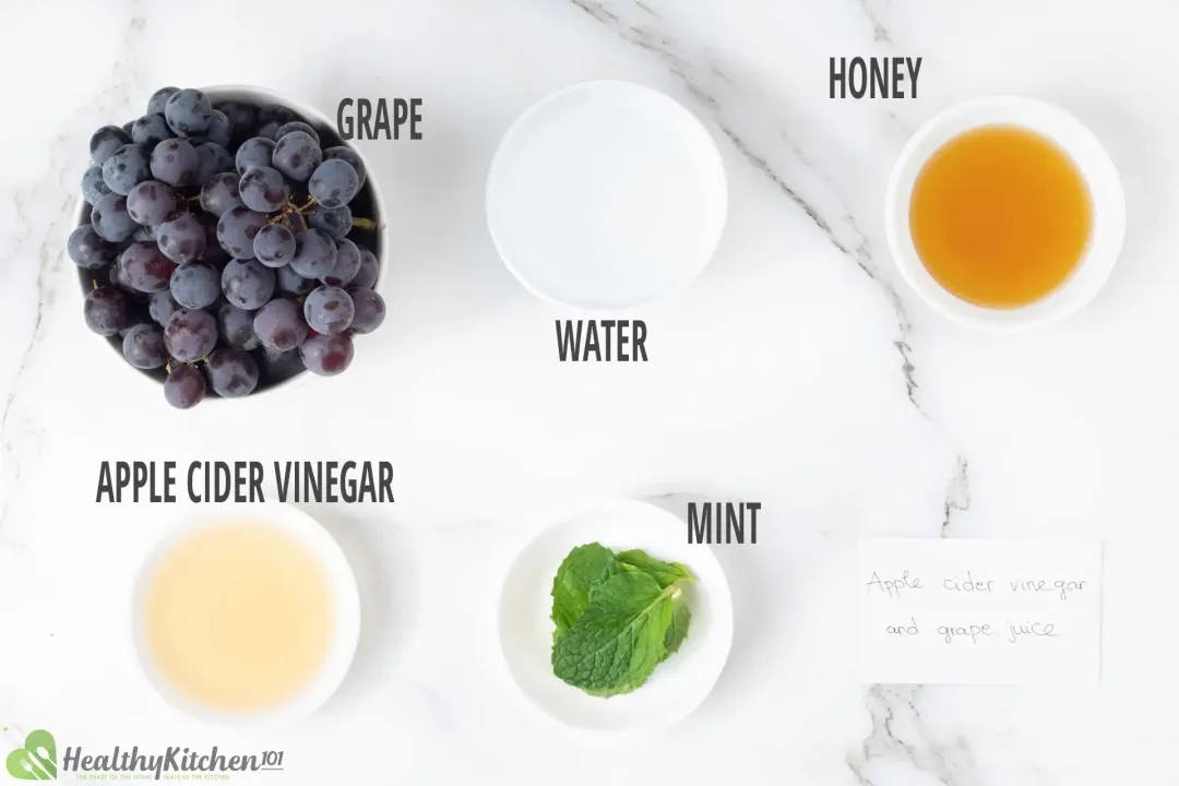 Ingredients in separate bowls: red grapes, water, honey, apple cider vinegar, and mints