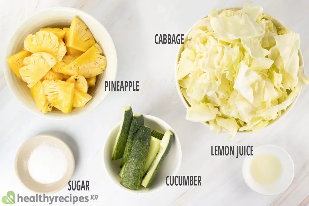 Ingredients in separate bowls: chunked cabbages, pineapple wedges, cucumber sticks, sugar, and lemon juice