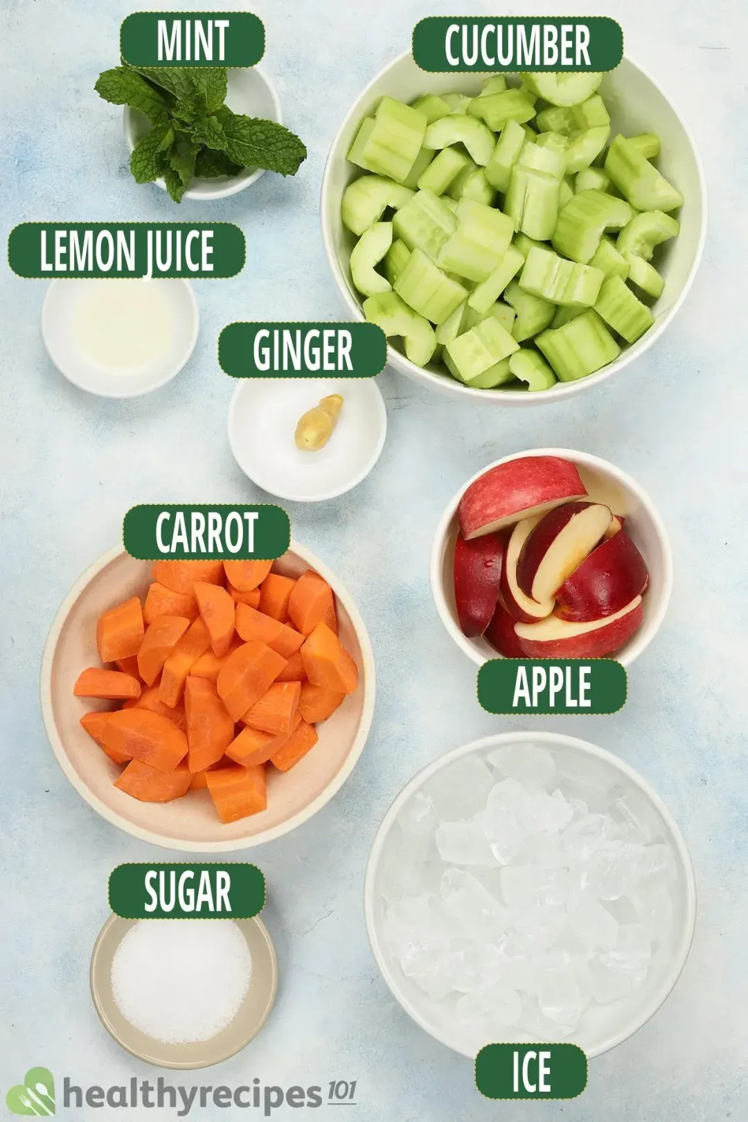 Ingredients in separate bowls: peeled and chunked cucumbers, apple quarters, mints, sugar, chunked carrots, ice nuggets, lemon juice