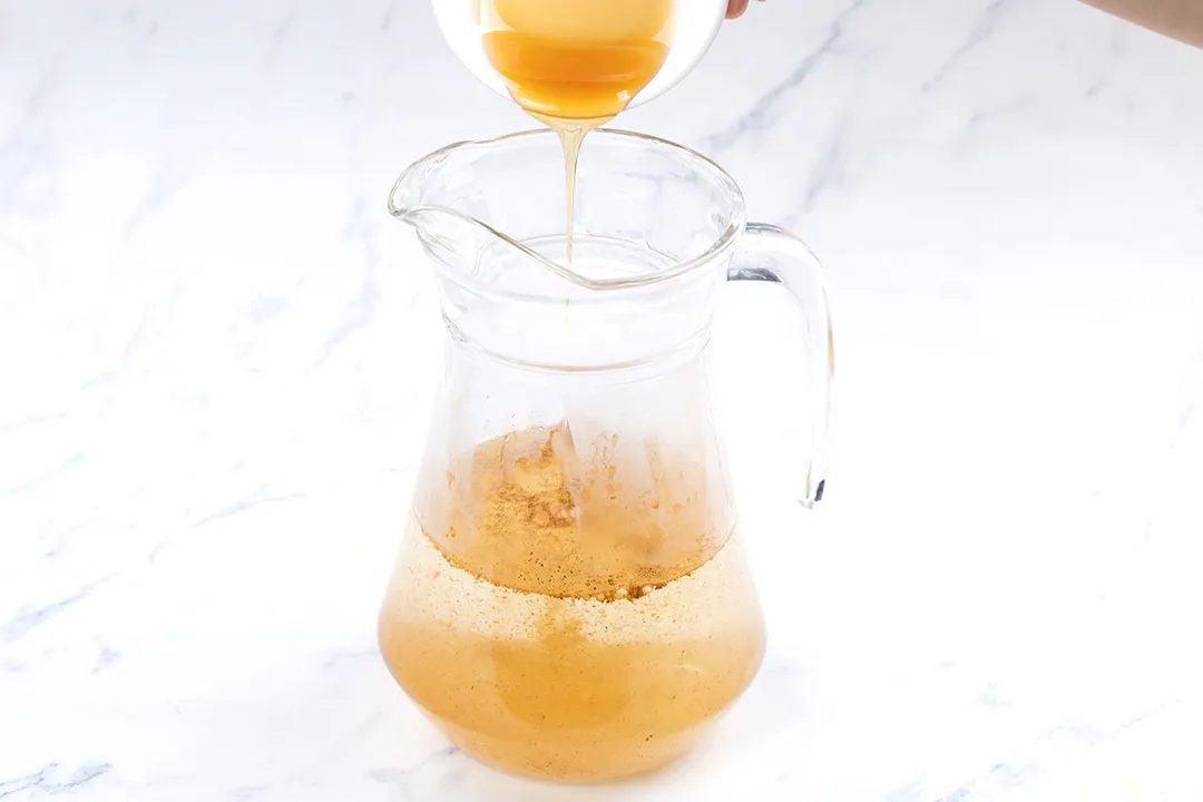 pouring hone from small bowl to a jar