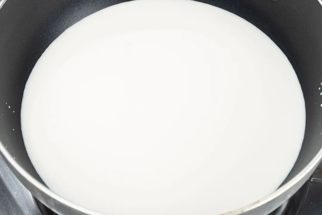 Some egg yolks beaten in a white bowl