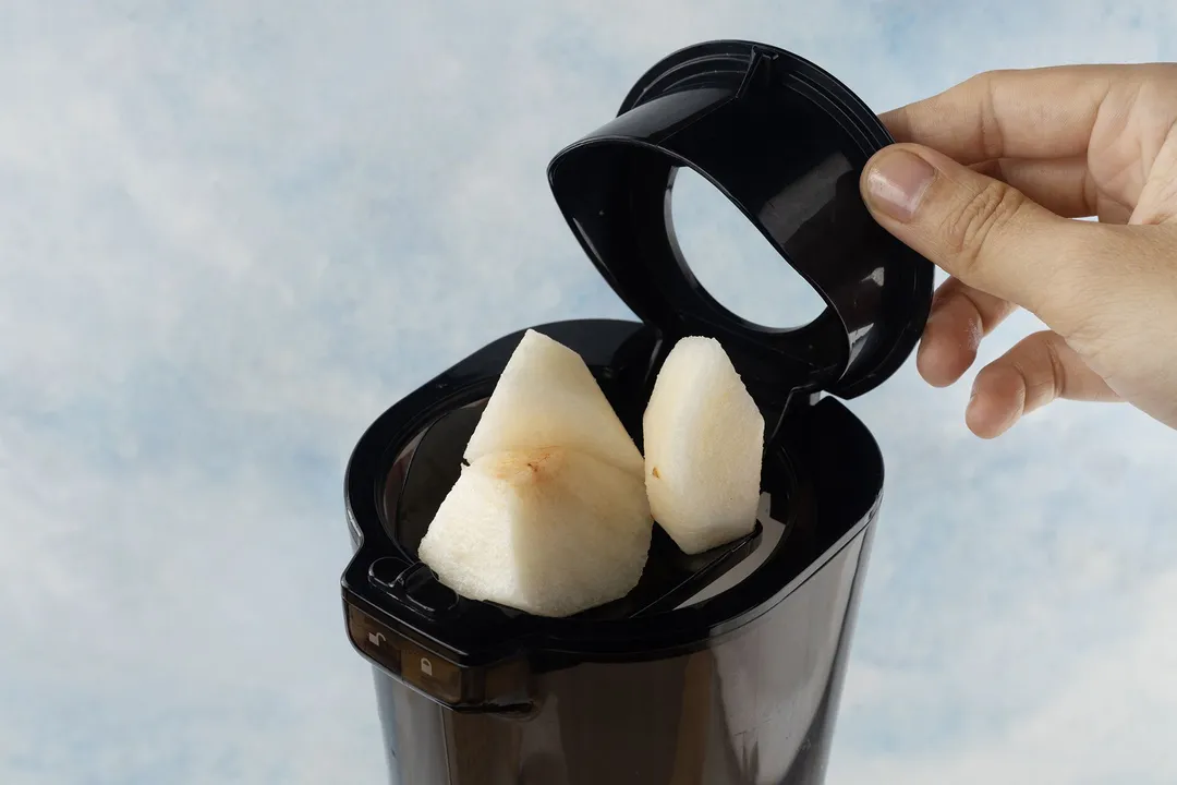 juicing pear in a juicer