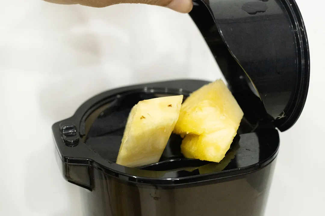 juicing pineapple in a juicer