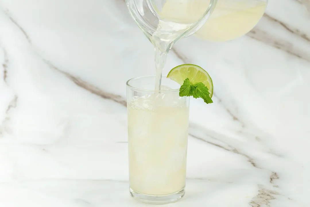 pouring juice from a pitcher into glass