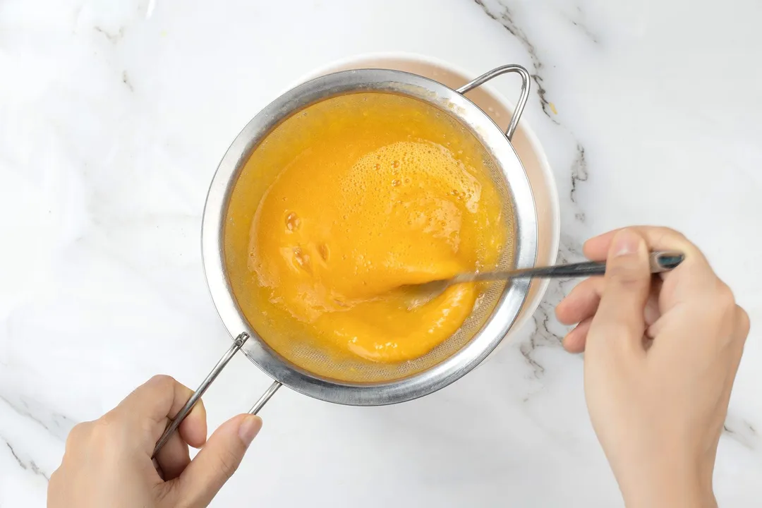 mango mixture into sieve