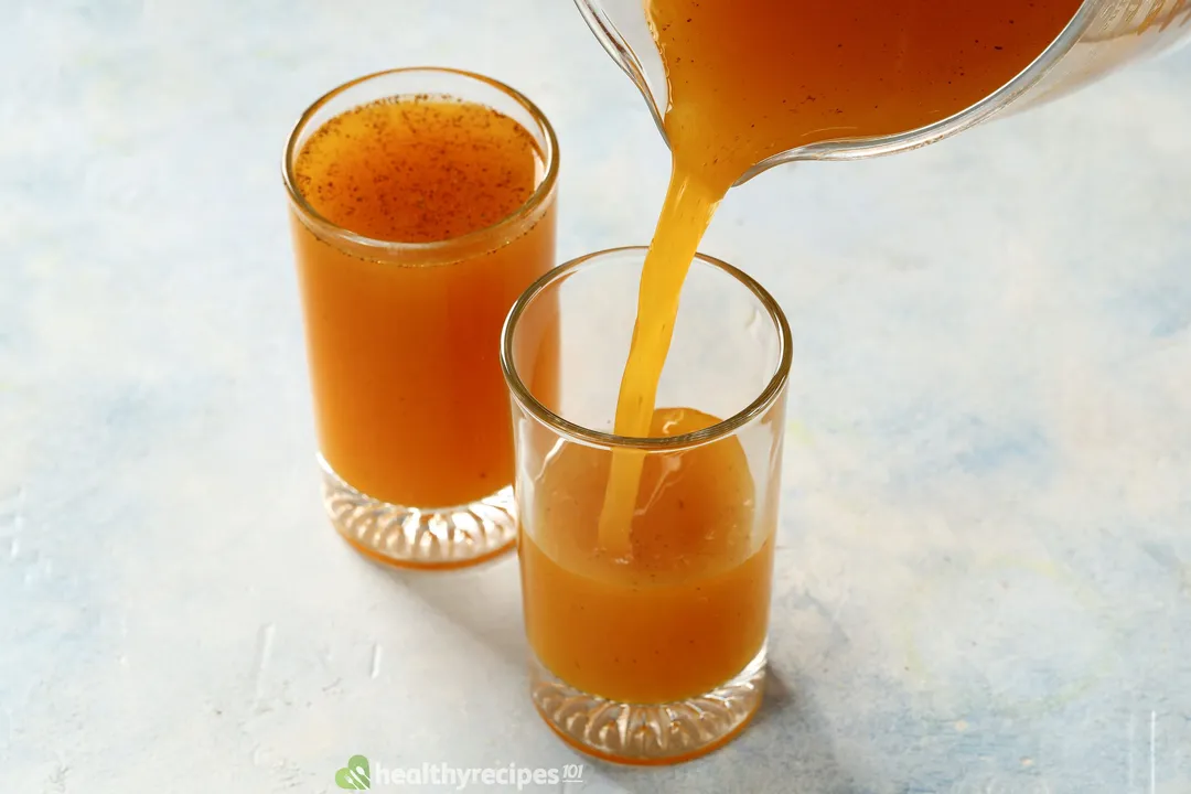 pouring yellow liquid from a pitcher into glasses