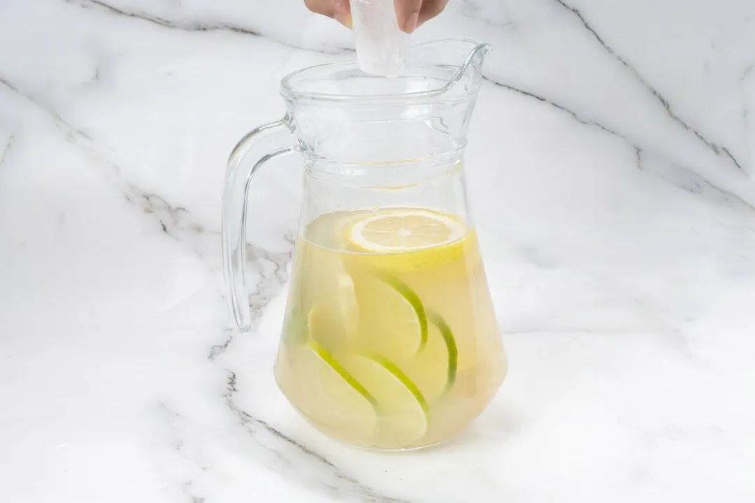 an ice cubed on top of a glass pitcher