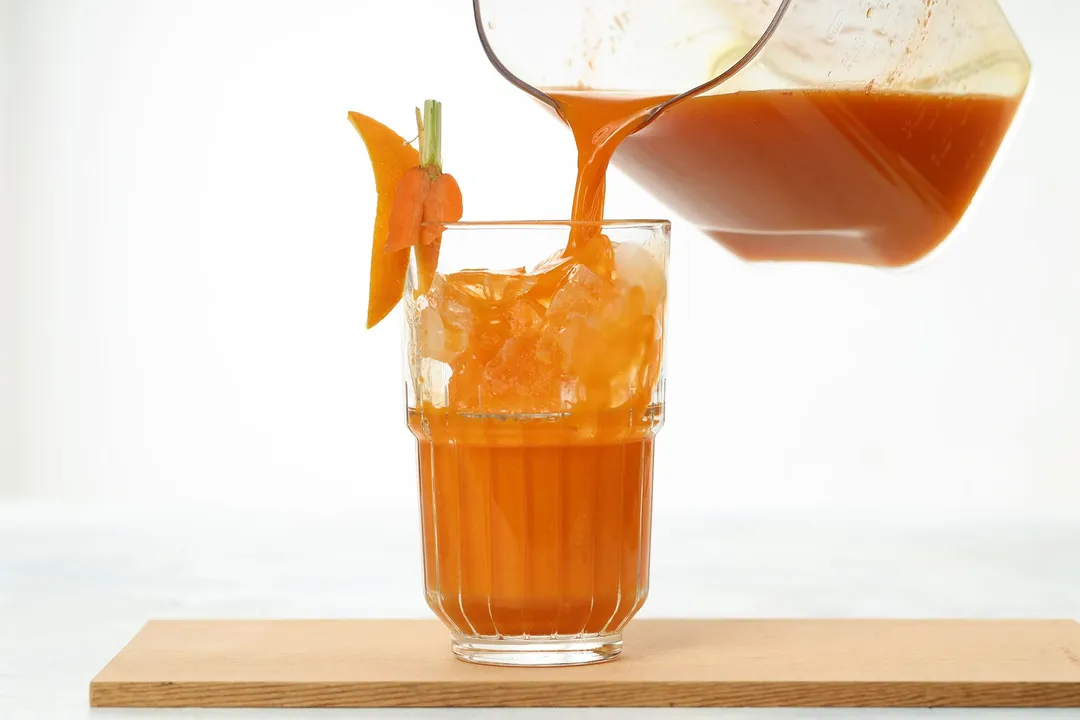 pouring juice from a pitcher into a glass