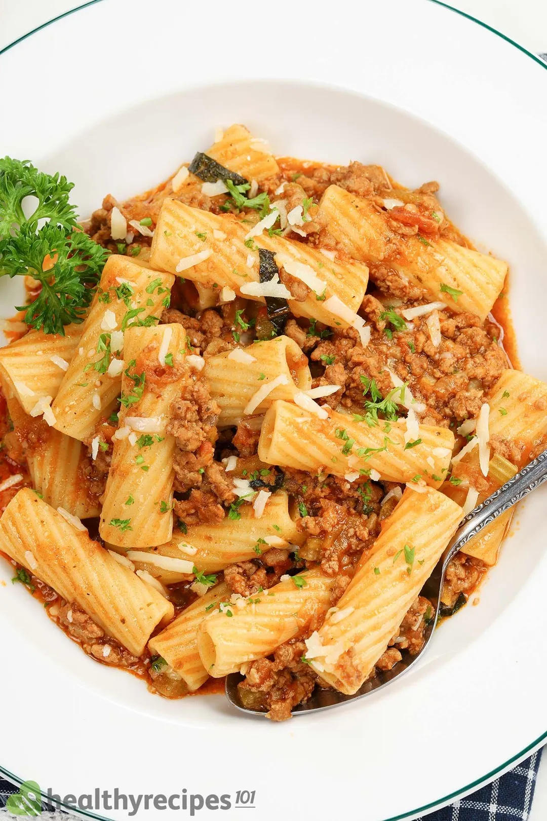 A white round plate filled with Pasta Bolognese