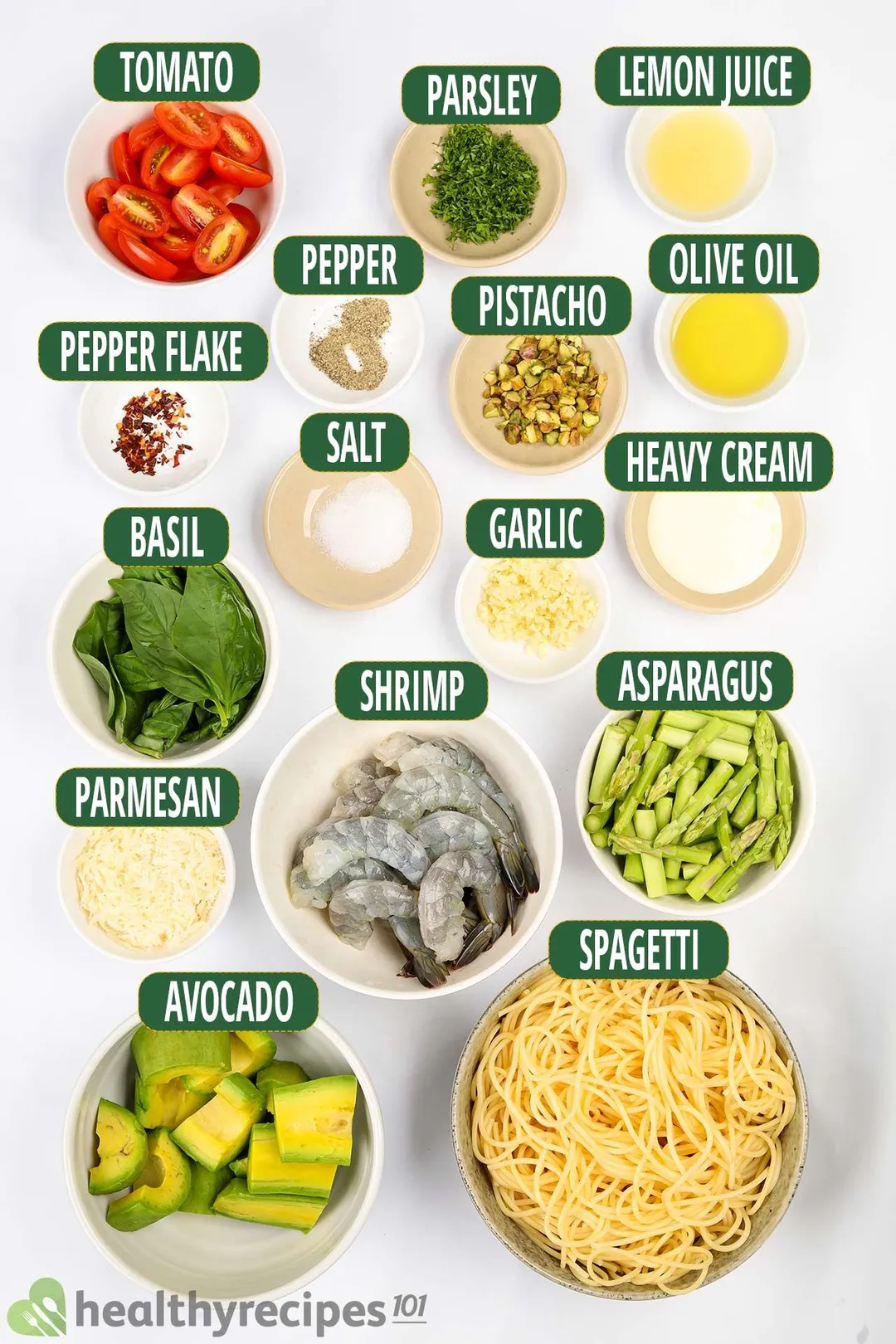 Ingredients for avocado pasta, including bowls of spaghetti, avocado slices, raw shrimp, and others.
