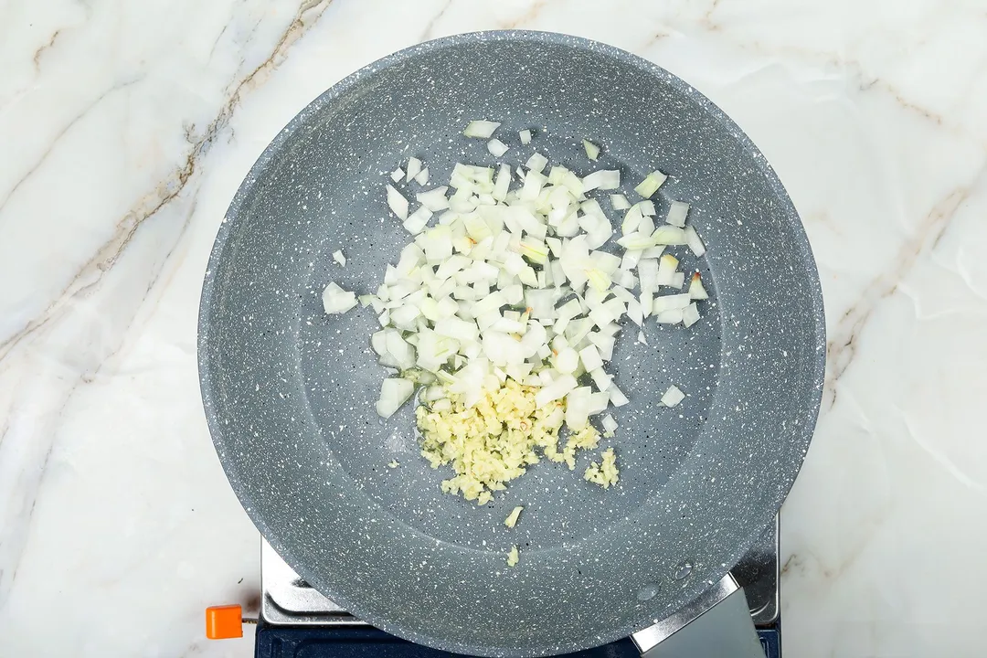 cooking minced garlic and onion in a skillet