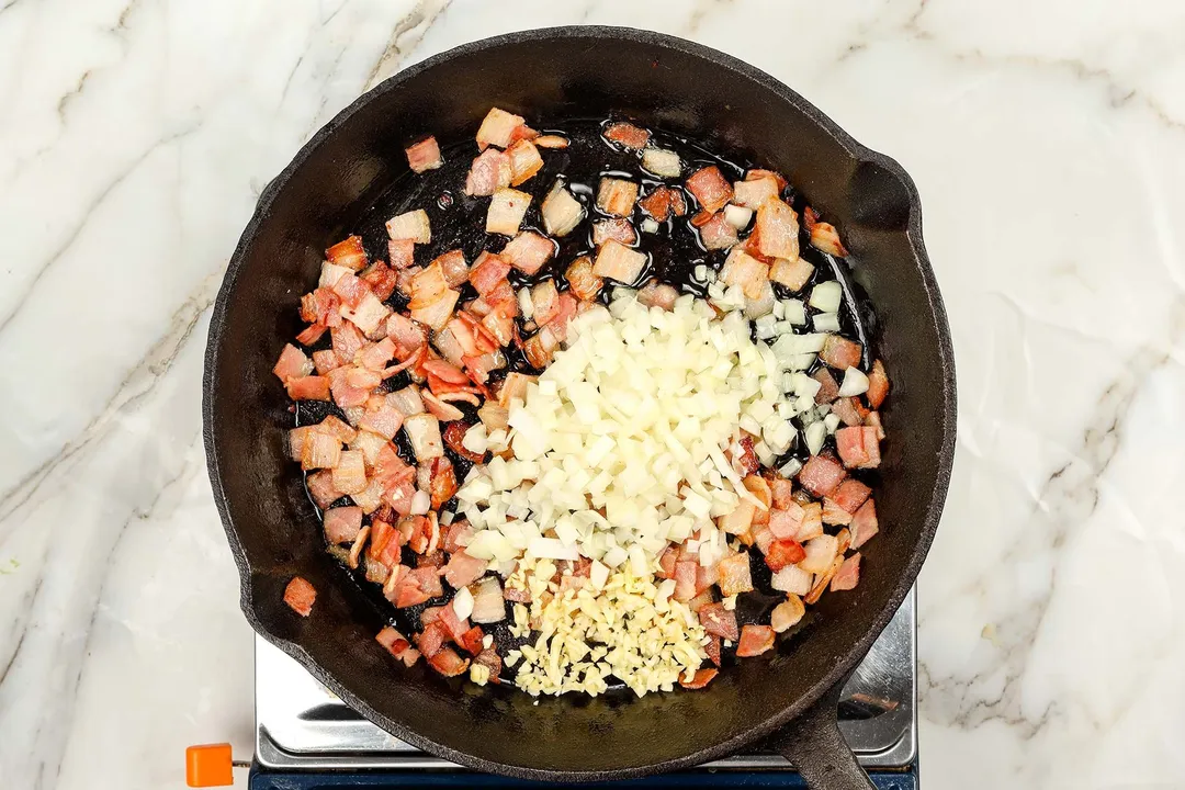 cooking minced onion, garlic and bacon in a cast iron skillet