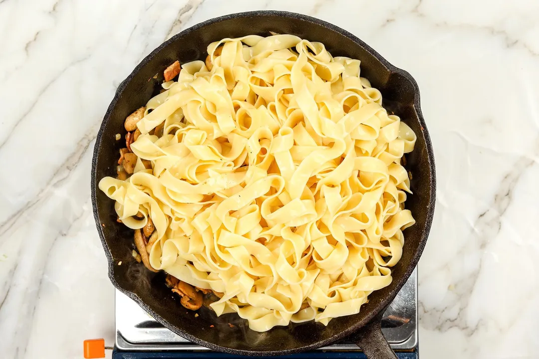 top view of a cast iron skillet of pasta