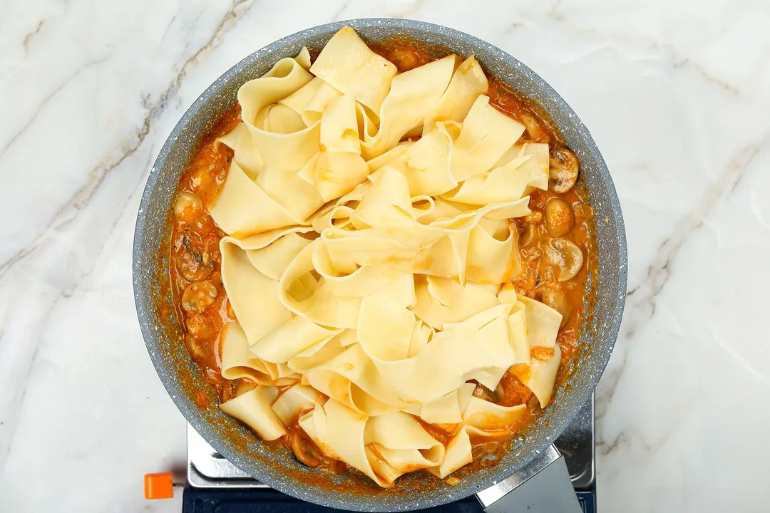 cooking paste and tomato sauce in a skillet