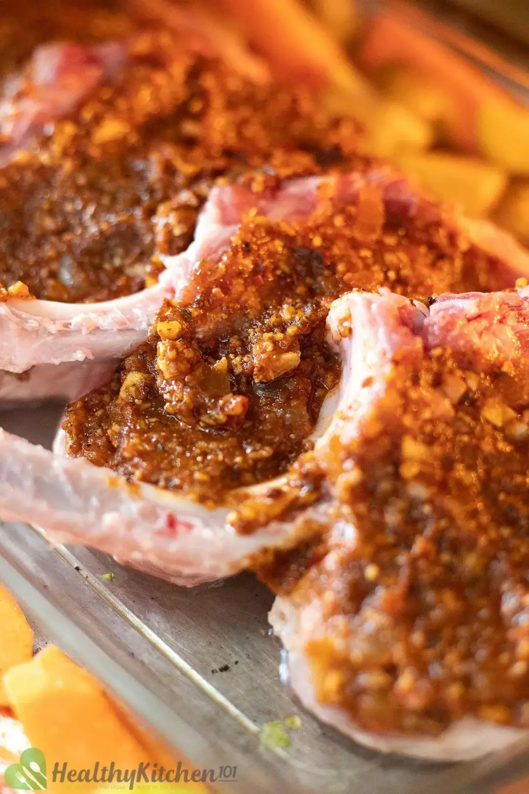 Raw pork chops covered in sauce