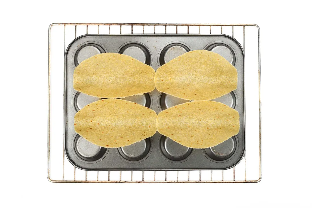 four corn tortillas laying on a tray
