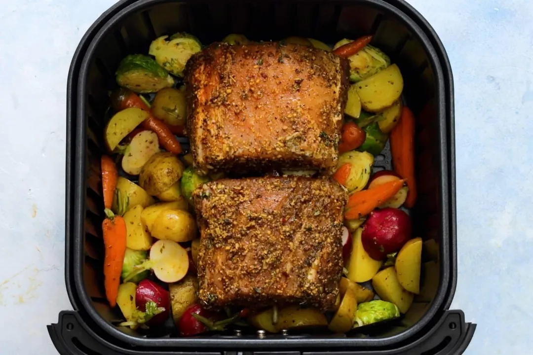 pork loin and vegetable in an air fryer basket