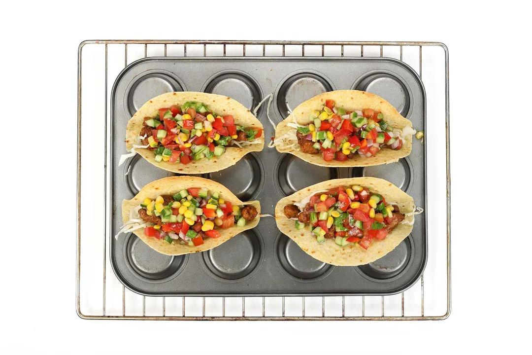 four tortillas and filling on a tray