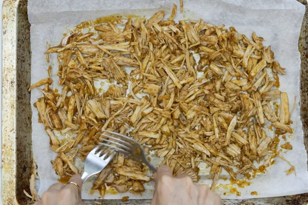 shredded meat on a baking tray