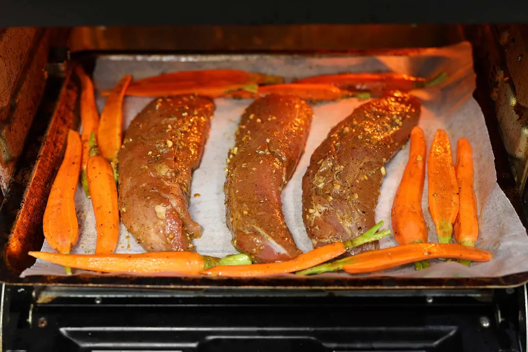 bake pork tenderloin and sliced carrot in the oven