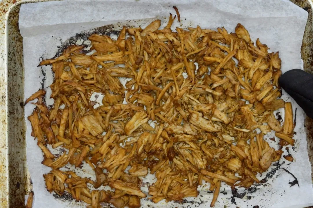 baked shredded meat on a baking tray