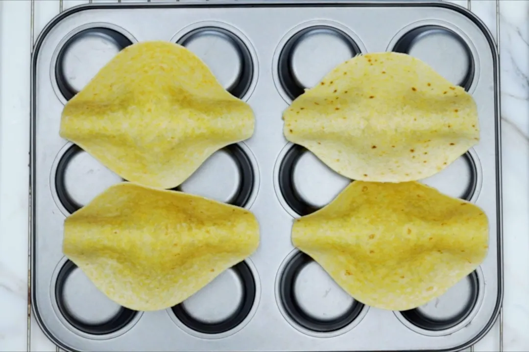 four corn tortillas on a tray