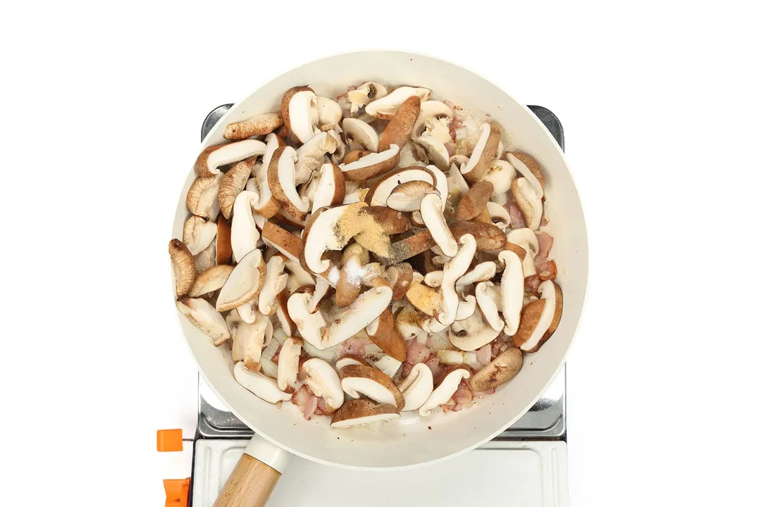 slices mushroom with seasoning in a skillet