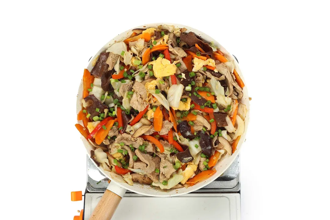 a skillet of cooked pork moo shu