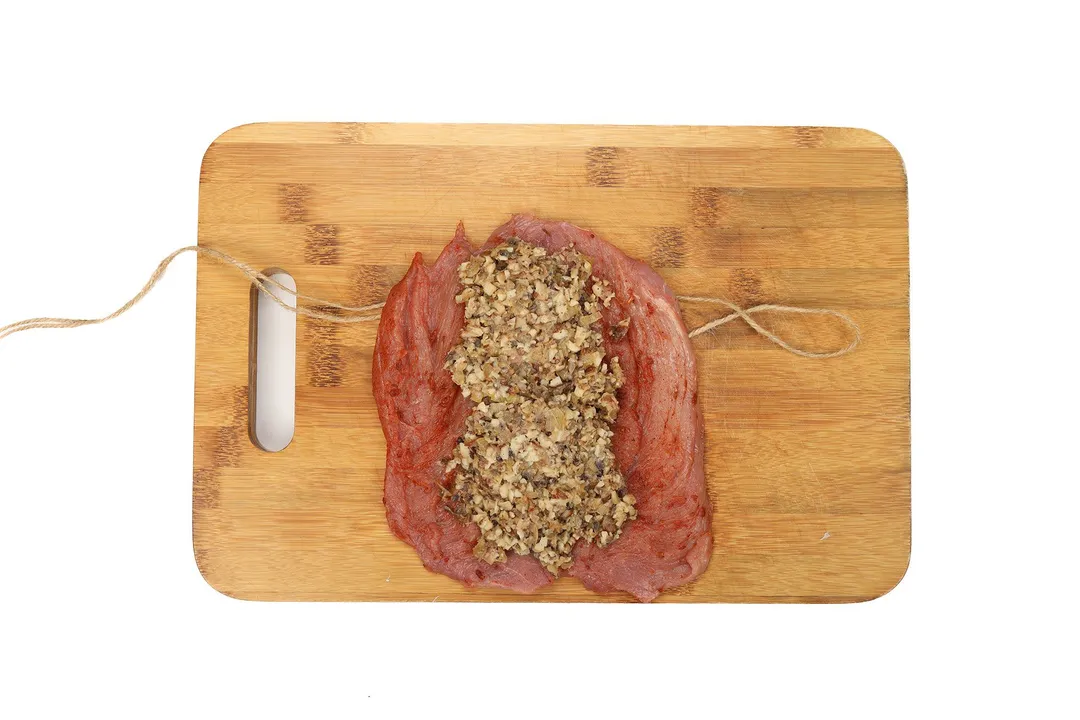 pork loin on a chopping board with filling in center