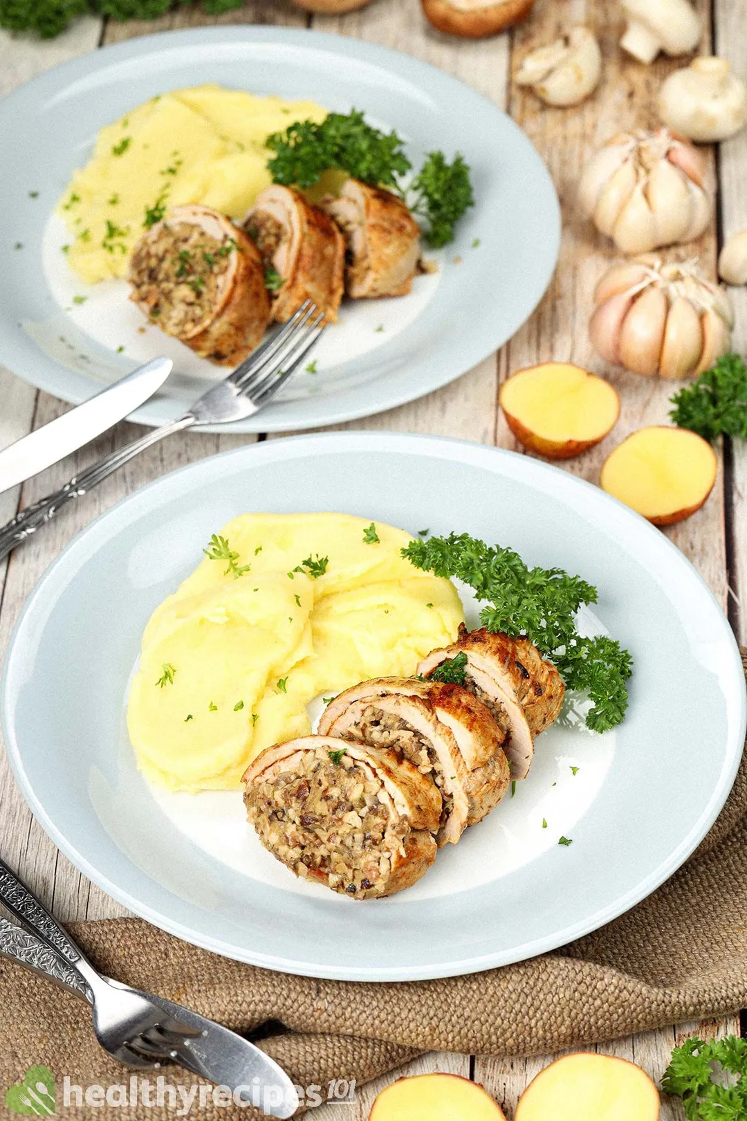 two plate of cooked stuffed pork loin