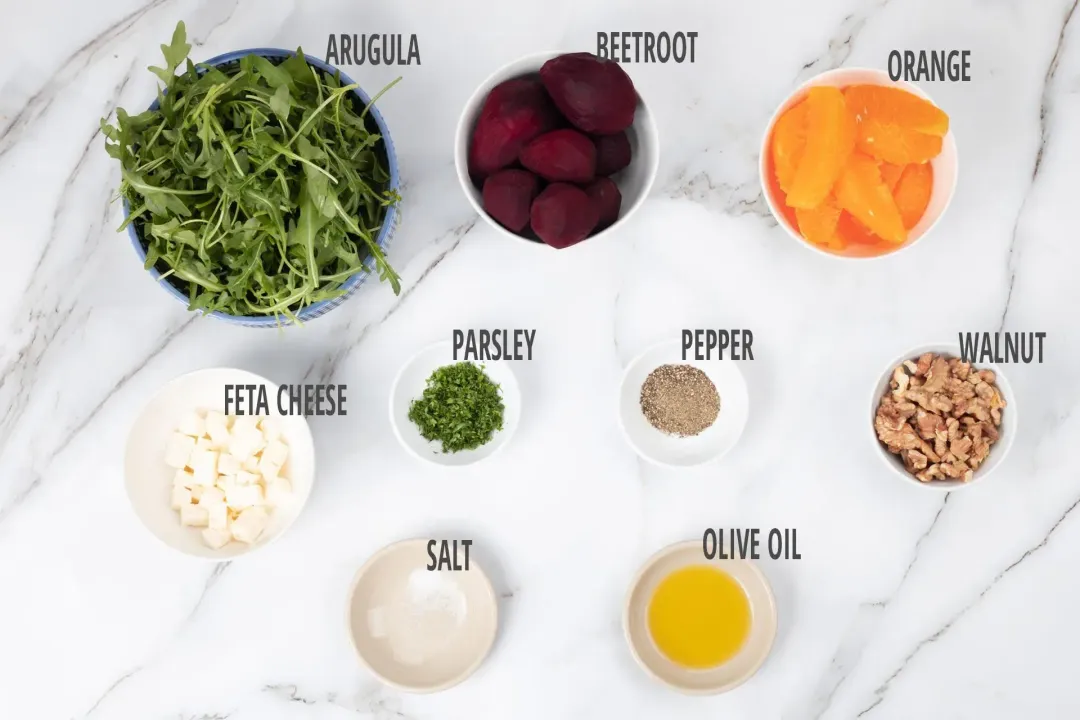 Ingredients for beet and feta cheese salad in separate bowls