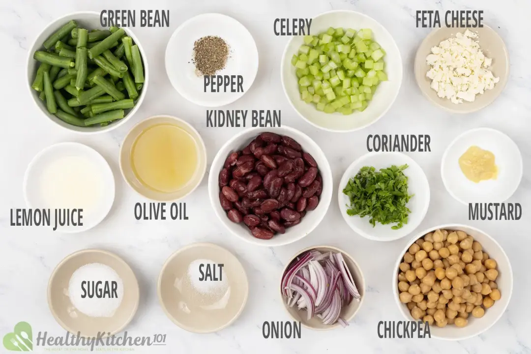 Ingredients for classic three-bean salad including green beans, kidney beans, chickpeas, celery, and other dressing ingredients