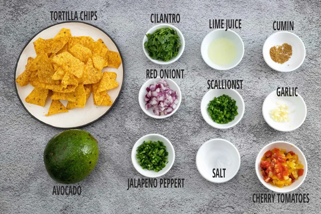 Tortilla chips, avocado, and guacamole ingredients in separate bowls