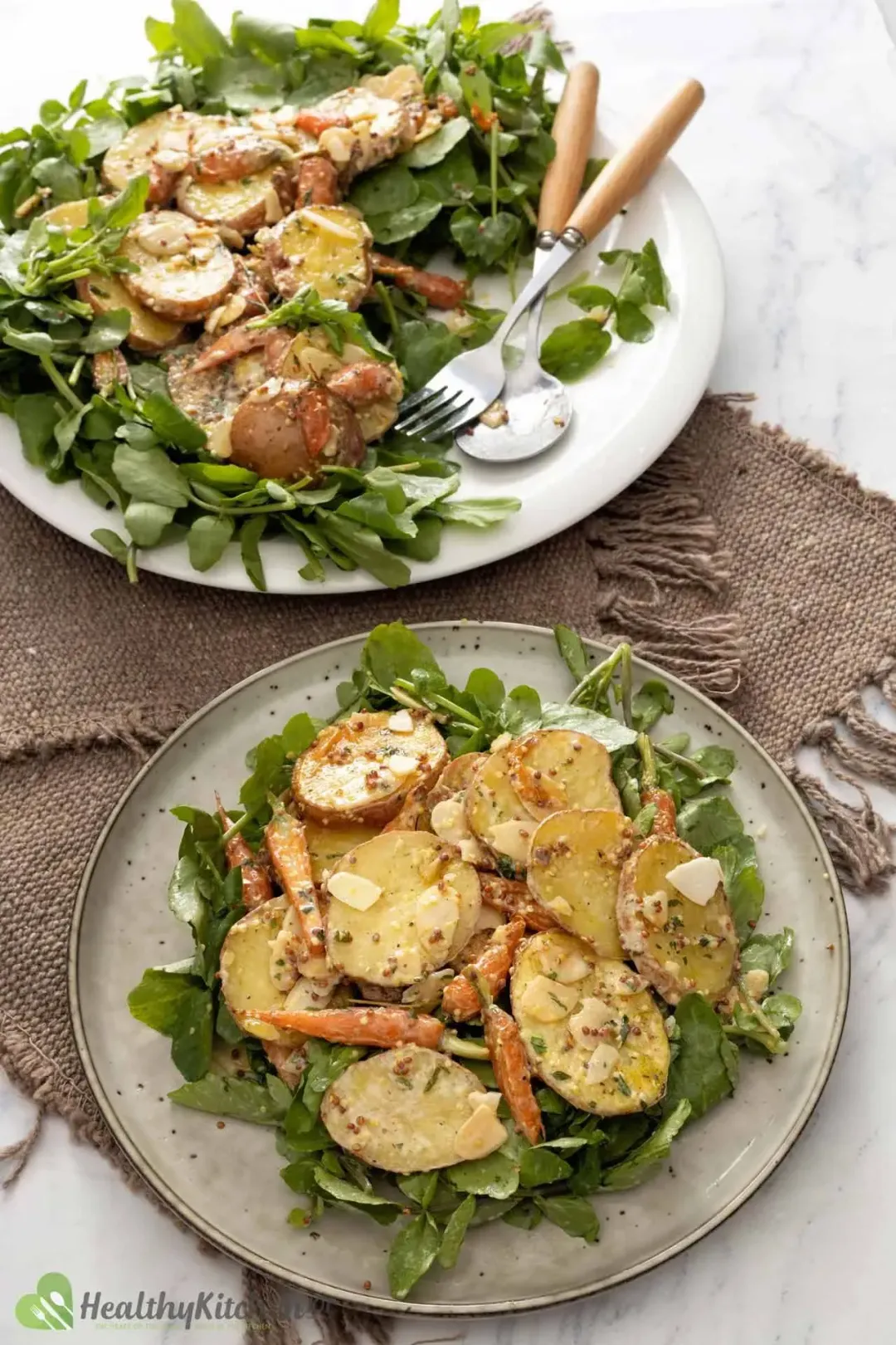 Baked potatoes salad in two platters with dressing