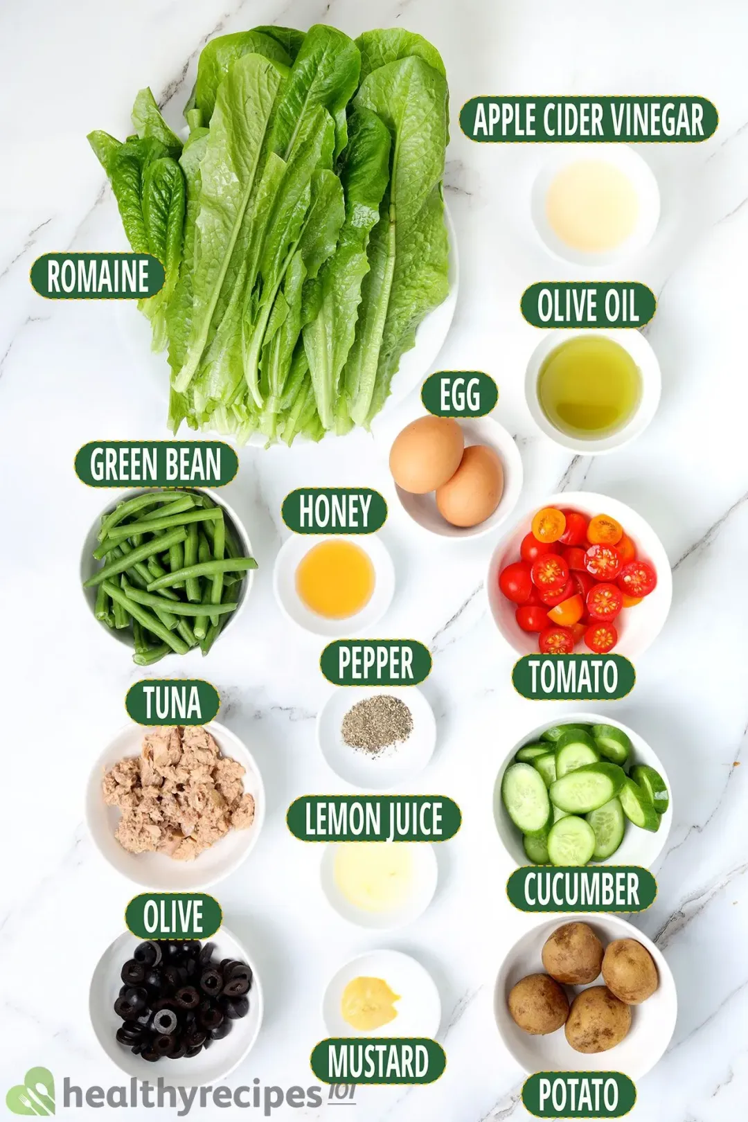 ingredients for Nicoise salad, including tuna, eggs, olives, and vegetables