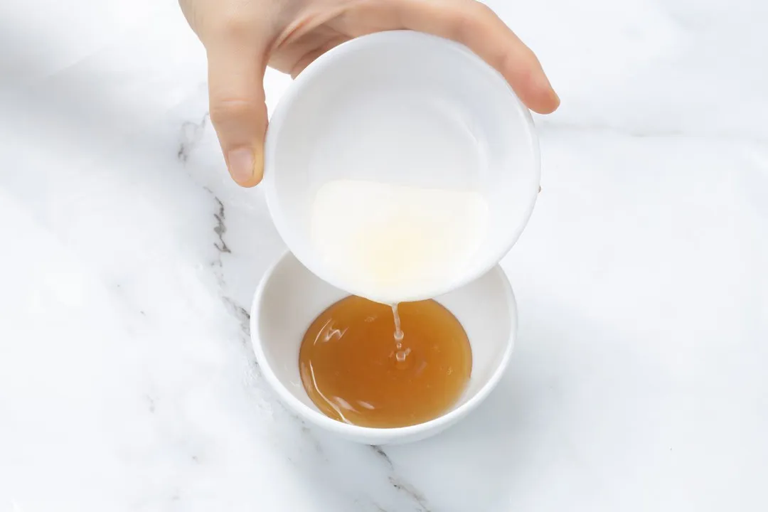 pouring lemon juice into a small bowl