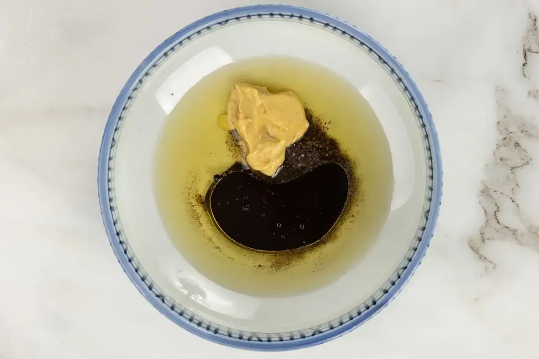 a bowl of Caesar salad dressing.