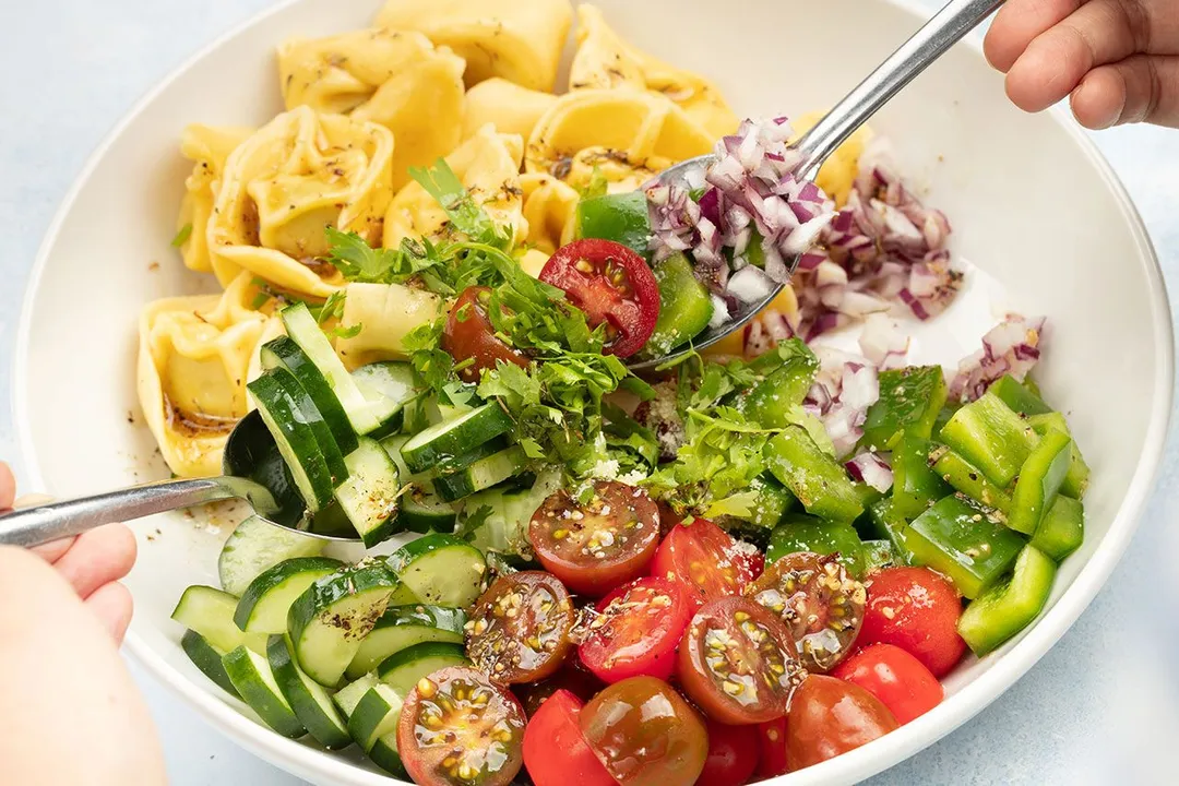 two spoon in a plate of salad