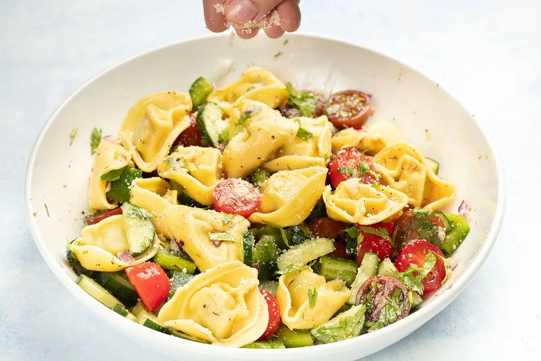 sprinkle cheese on top of salad plate