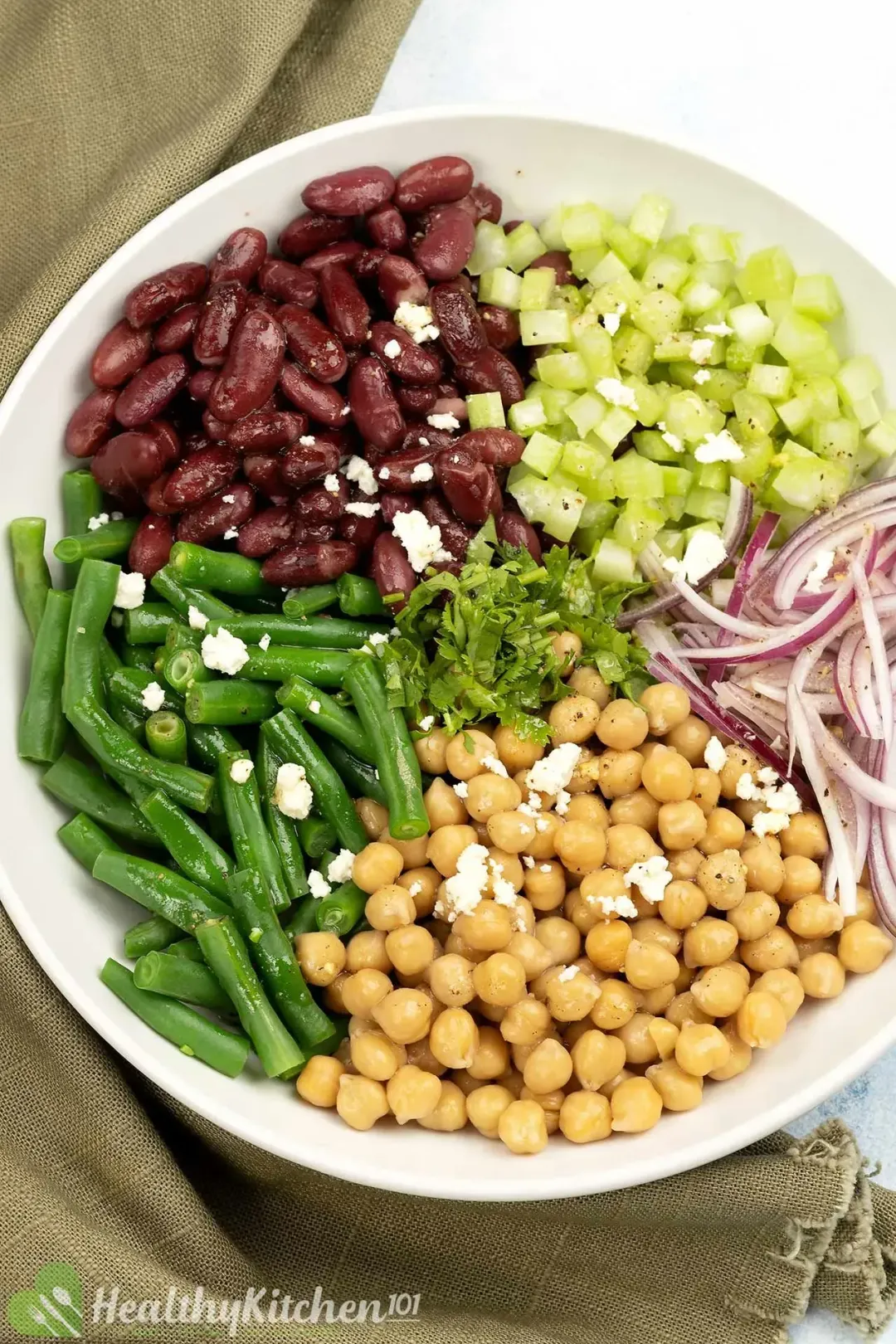 A platter of three-bean salad with green beans, kidney beans, chickpeas, onions, and udamame